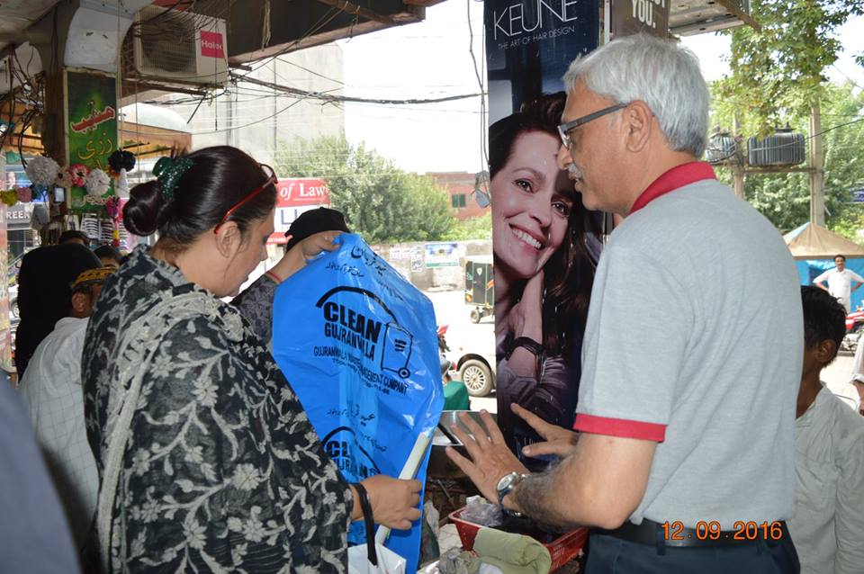 MD GWMC Dr Atta-ul-Haq distributing waste Bags in General public