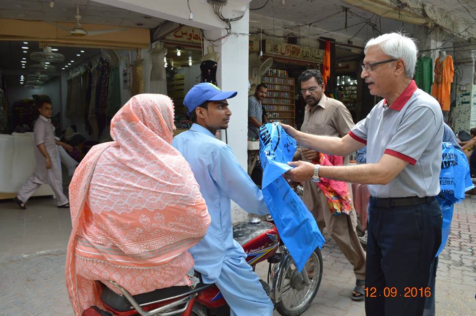 MD GWMC Dr Atta-ul-Haq distributing waste Bags in General public