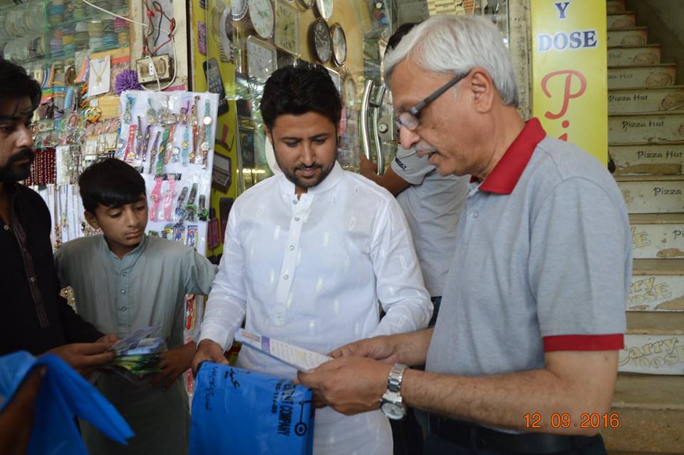 MD GWMC Dr Atta-ul-Haq distributing waste Bags in General public