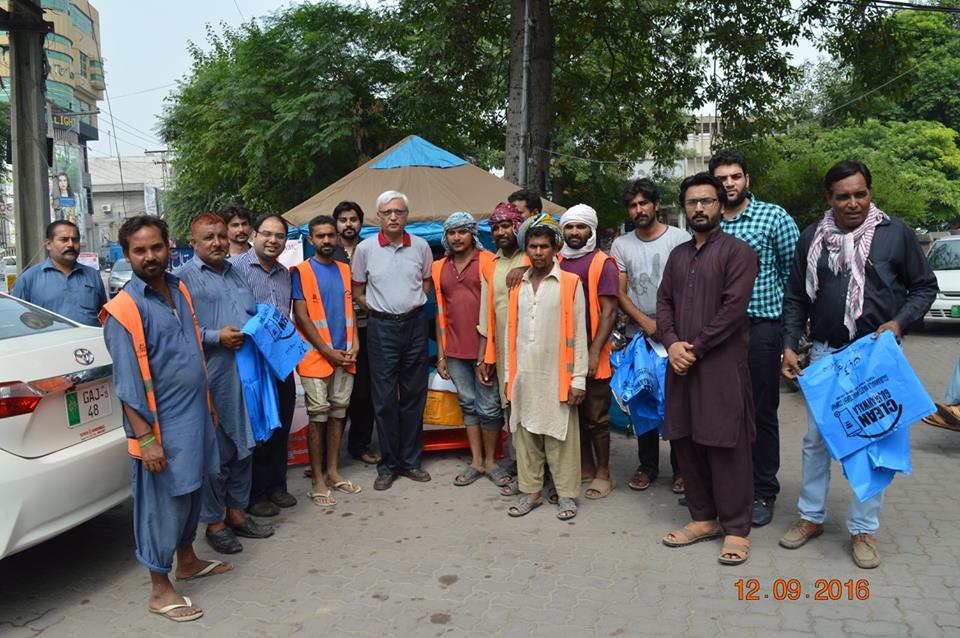 MD GWMC Dr Atta-ul-Haq distributing waste Bags in General public